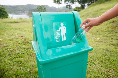 Operatives using PPE and handling waste containers safely